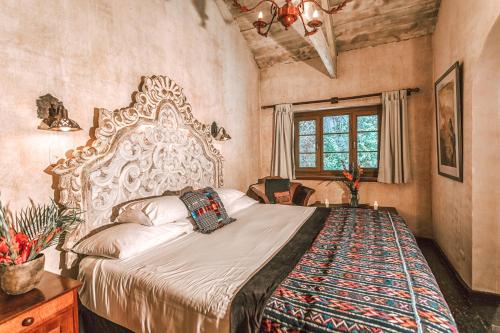 a bedroom with a large bed in a room at Meson Panza Verde in Antigua Guatemala