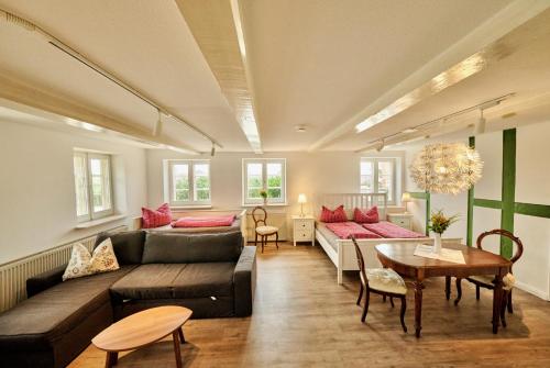 a living room with a couch and a table at Hausdeich in Hamburg
