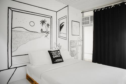 a bedroom with a drawing of a bed with a sign on it at Suyog Life Siargao in General Luna