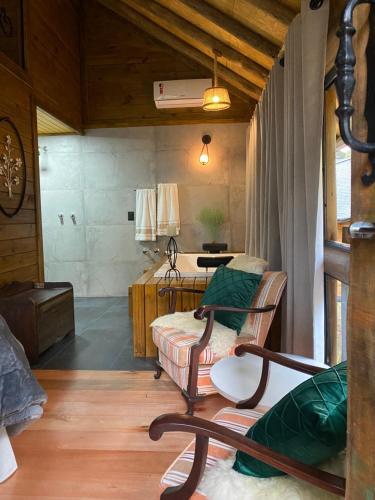 a room with a bed and a couch and a table at Eco Pousada Invernador in Urubici