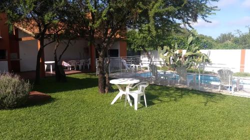 a patio with a table and chairs in a yard at Cabañas Luna del Sur in Merlo