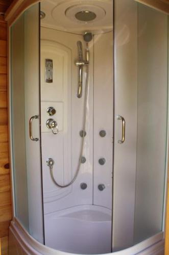 a shower with a glass door in a bathroom at Haapsu Holiday Home in Haapsu