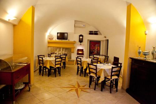 a dining room with tables and chairs in a restaurant at Villa Musica in Sannicola