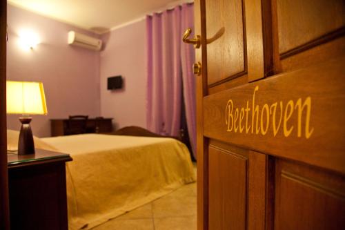 a bedroom with a bed and a door with the word bedroom at Villa Musica in Sannicola