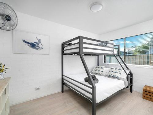 a bedroom with a bunk bed and a window at Bayswell by Experience Jervis Bay in Huskisson