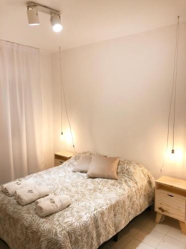 a bedroom with a bed with two pillows on it at RIO 1 Departamento temporario con cochera in Villa María