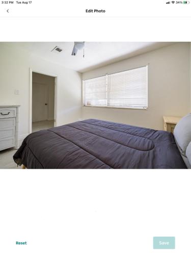 a bedroom with a large bed and a window at Spacious 4 bdr 2 bath home 10min to the beach Aventura mall in Hallandale Beach