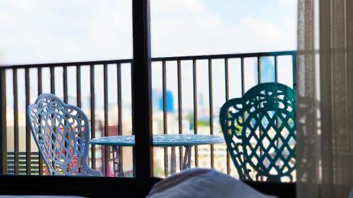 two chairs and a table on a balcony at Many Holiday The Base Condo in Pattaya Central