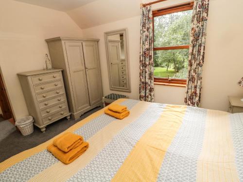 En eller flere senger på et rom på Groom's Cottage