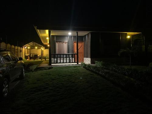 a house at night with a car parked in front of it at Cabaña El Monasterio in Fortuna