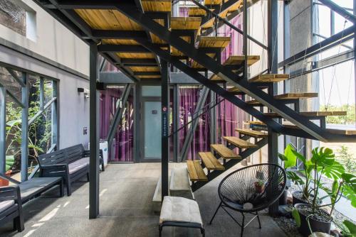 a hallway of a building with stairs and benches at Top Sunlight Inn in Xiaoliuqiu