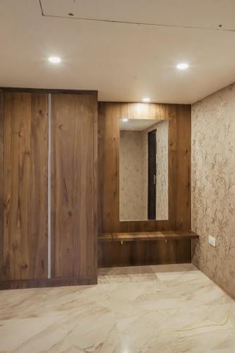 a room with wooden walls and a mirror at Regenta Central Somnath, Bhalpara in Somnath