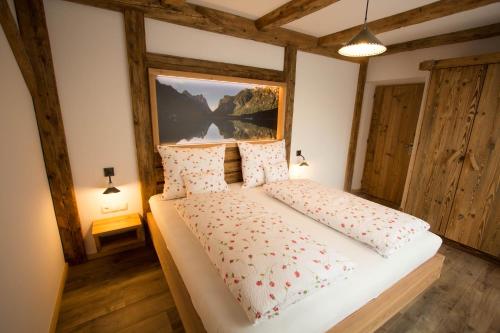 a bedroom with a large bed in a room at Mutznhof in Dobbiaco