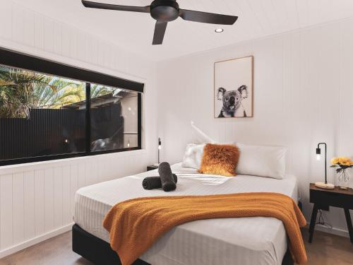 a bedroom with a bed and a ceiling fan at Poplar Villa - 1 Poplar Lane in Evans Head