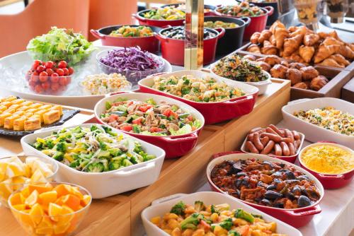 a buffet of different types of food on a table at Candeo Hotels Ueno Park in Tokyo