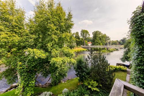 a view of a river with trees and a bridge at Lossi 8 -4 Põltsamaa Maida in Põltsamaa