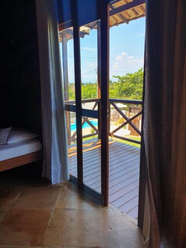 an open door to a balcony with a view at Pousada Dunas do Icarai in Icaraí