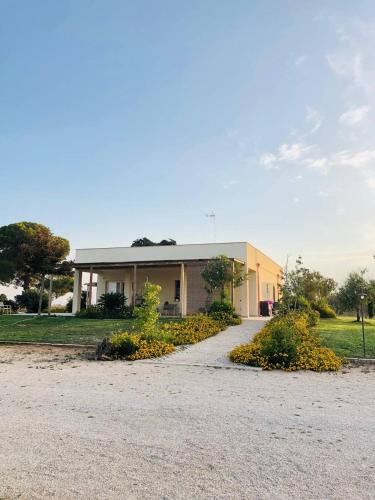 a building with a driveway in front of it at Le stanze di chiara in Torre Lapillo