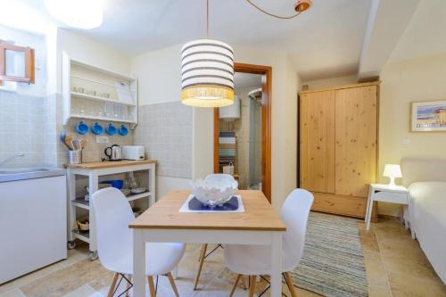 eine Küche und ein Esszimmer mit einem Tisch und Stühlen in der Unterkunft Apartment Sympa in Dubrovnik