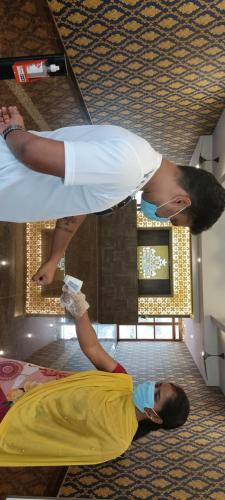 two people standing on the floor in a room at Royal Destiny Resort in Malaiyāndipattanam