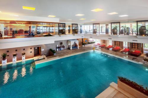 a large swimming pool in a hotel lobby at Grand Millennium Beijing in Beijing