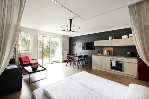 uma grande sala de estar com uma cama e uma cozinha em HOMEBOUND APARTMENTS Salzburg City II - contactless check-in em Salzburgo