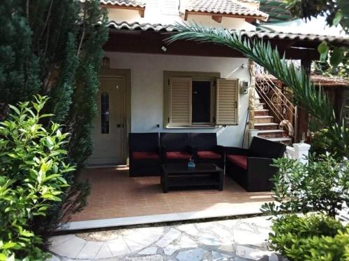 a patio with a couch and a stair case at Bochtis Acrogiali in Ammoudia