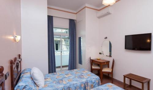 Ένα ή περισσότερα κρεβάτια σε δωμάτιο στο Hôtel Astrid