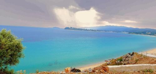 a view of a beach with blue water at Ktima Argiri in Ormos Panagias