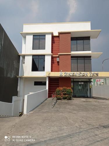 a white and red building with a sign on it at 8 Zhensen Inn in Bacoor