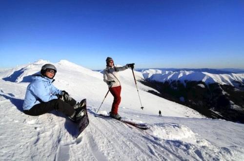 two people on top of a snow covered mountain at Romantická chalupa pod Vysokými Tatrami in Liptovský Hrádok
