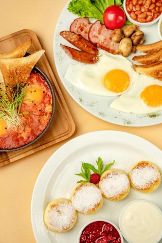 a table with two plates of breakfast food on it at ZIG ZAG in Kamianets-Podilskyi