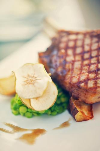 a plate of food with a piece of meat and vegetables at Premier Splendid Inn Bloemfontein in Bloemfontein