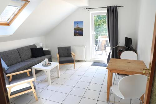 a living room with a couch and a table at Haus Anker in Sankt Peter-Ording