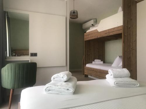 a bedroom with two folded towels on a bed at AKSOY TAŞ EV in Bodrum City