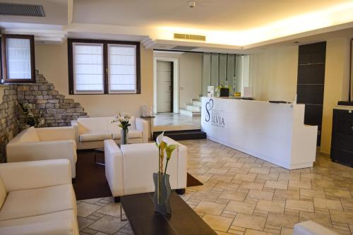 
a living room filled with furniture and a large window at AHG Donna Silvia Hotel Wellness & SPA in Manerba del Garda
