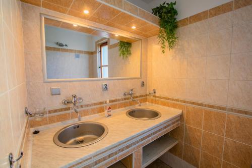 a bathroom with two sinks and a mirror at Privát NA CHALUPE Partizánska Ľupča 649 in Partizánska ľupča
