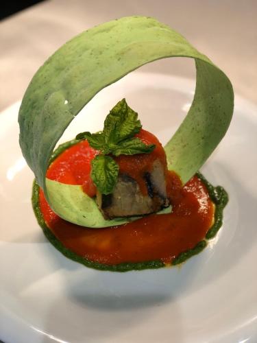 a food entree with meat and tomato sauce on a plate at Club Maspalomas Suites & Spa - Adults Only in Maspalomas