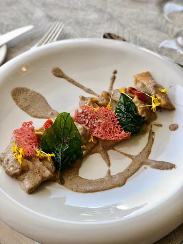 a white plate with some food on it at Club Maspalomas Suites & Spa - Adults Only in Maspalomas
