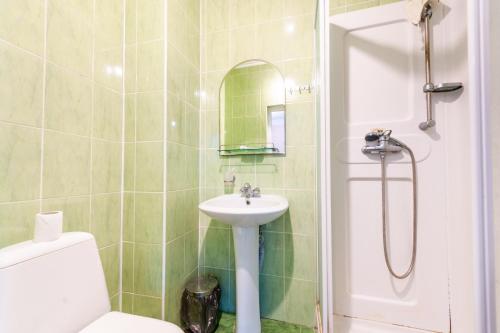 a bathroom with a sink and a toilet and a shower at гостевой дом "Максим" in Novomikhaylovskiy