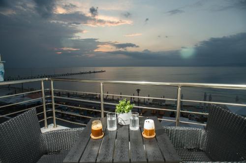a table on a cruise ship with two glasses of beer at Lux VIP Apartments in Perea