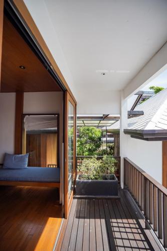 a guest house with a bed on a deck at Chann Bangkok Noi in Bangkok