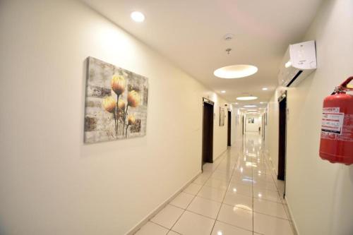 a hallway in a hospital with a painting on the wall at شقق روعه المصايف للشقق المخدومه in Taif