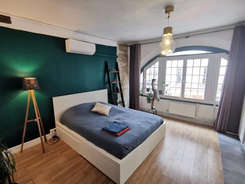 een slaapkamer met een bed en een groene muur bij Central & nice ! 3 bedrooms, 2 bathrooms in Parijs
