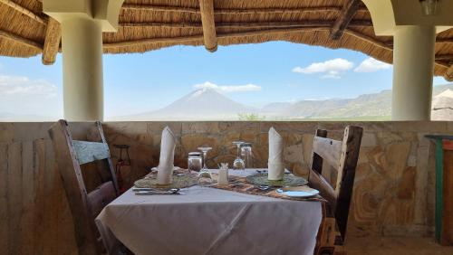 a table with candles on it with a view of a mountain at Africa Safari Lake Natron Camping in Mtowabaga