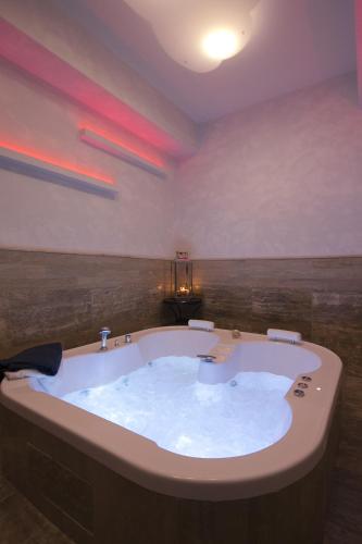 a large bath tub in a bathroom with red lights at Piccolo di Piazza di Spagna Suites in Rome