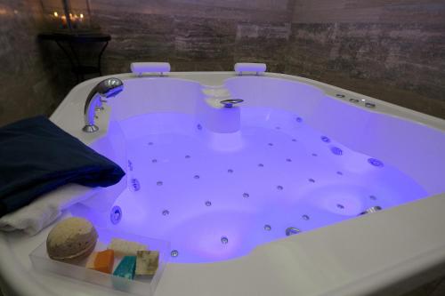 a large bath tub with a faucet in a bathroom at Piccolo di Piazza di Spagna Suites in Rome