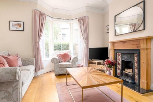 a living room with a fireplace and a mirror at Host & Stay - Railman's Rest in Whitby