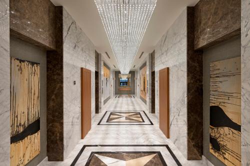 a hallway with a tile floor and a ceiling at Limak Skopje Luxury Hotel in Skopje