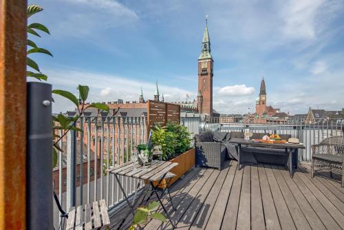 a balcony with a table and a view of a city at City Square Hotel Apartments in Copenhagen